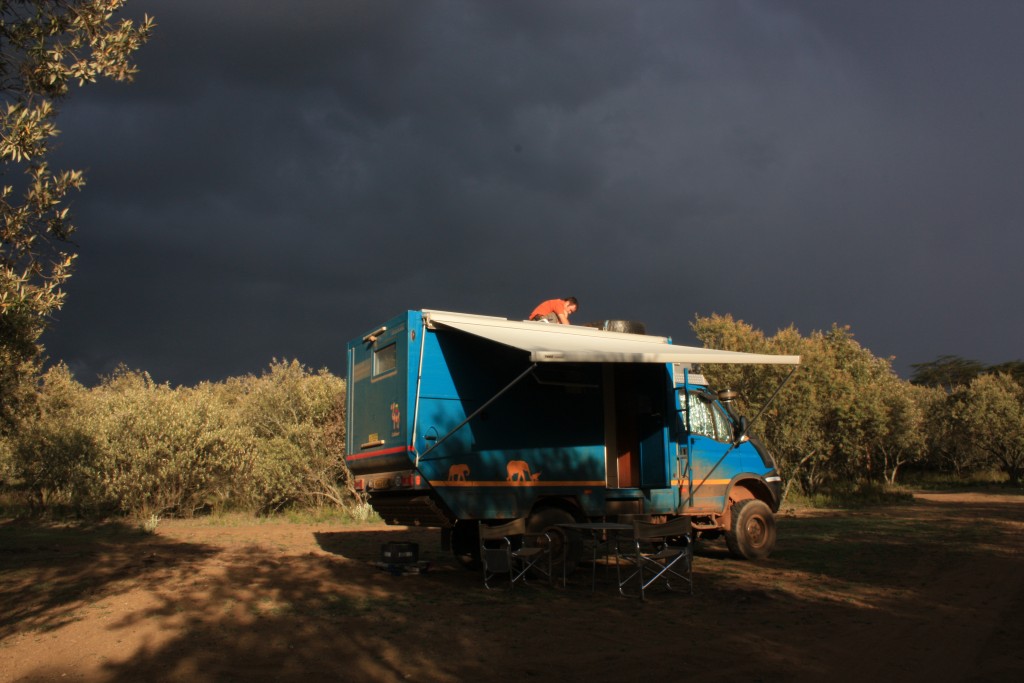 A 'Mzungu' on his truck with a storm brewing!