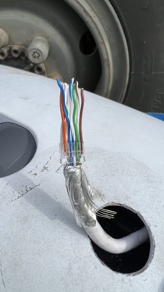 The untwisted ethernet cable inserted into the holder ready for trimming