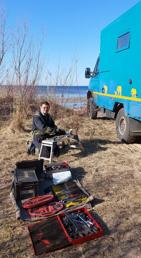 overlanding baltics , truck workshop on beach